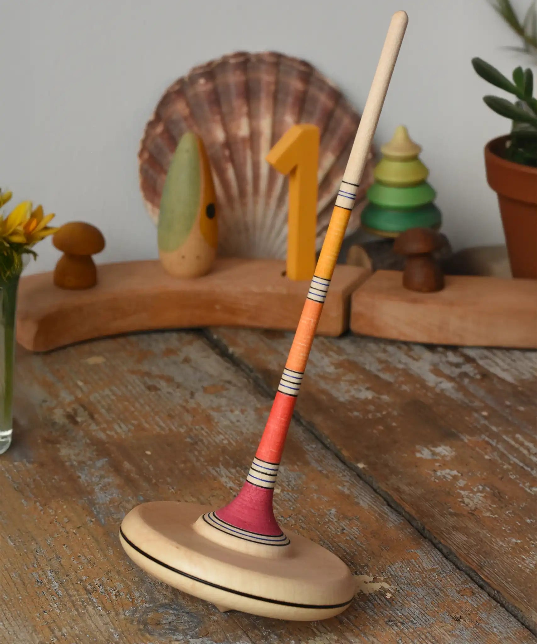Mader Kreiselmanufaktur large Arabella spinning top placed on a wooden surface in the Babipur playroom. 