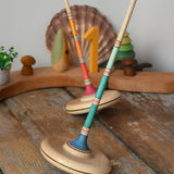 Mader Kreiselmanufaktur Large Arabella Spinning Tops placed on a wooden surface in the Babipur playroom.