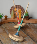 Mader Kreiselmanufaktur Large Arabella Spinning Tops placed on a wooden surface in the Babipur playroom.