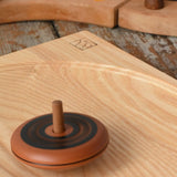 Mader Kreiselmanufaktur leporello wooden spinning top spinning on an ash spinning plate in the Babipur playroom.
