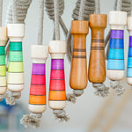 Made eco-friendly linen skipping ropes hanging in front of a grey background