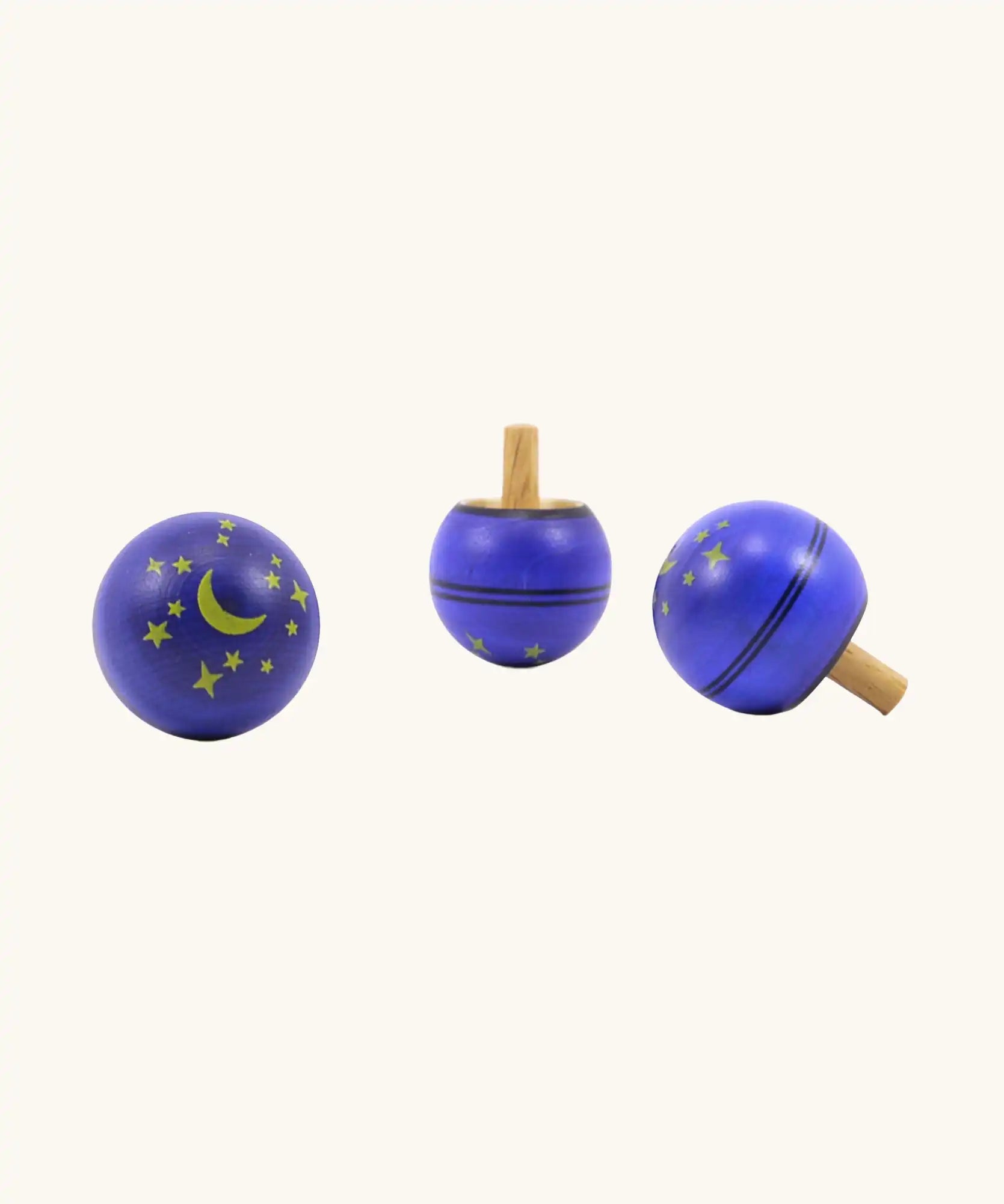 Three Mader Luna turn over wooden spinning tops.