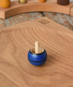 Mader Luna turn over spinning top shown on an oak spinning plate in the Babipur playroom.
