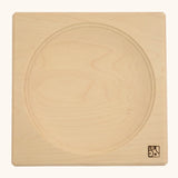 Mader handcrafted maple square medium spinning top plate. Showing the logo on the bottom corner