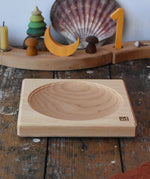 Mader ash medium wooden spinning plate 15cm placed on a wooden surface in the Babipur playroom.
