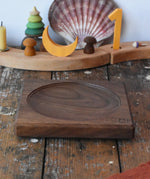 Mader walnut medium wooden spinning plate 15cm placed on a wooden surface in the Babipur playroom.