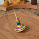 Mader Monalotte Spinning Top on a oak spinning plate in the Babipur playroom.