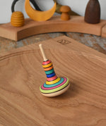 Mader Monalotte Spinning Top on a oak spinning plate in the Babipur playroom.