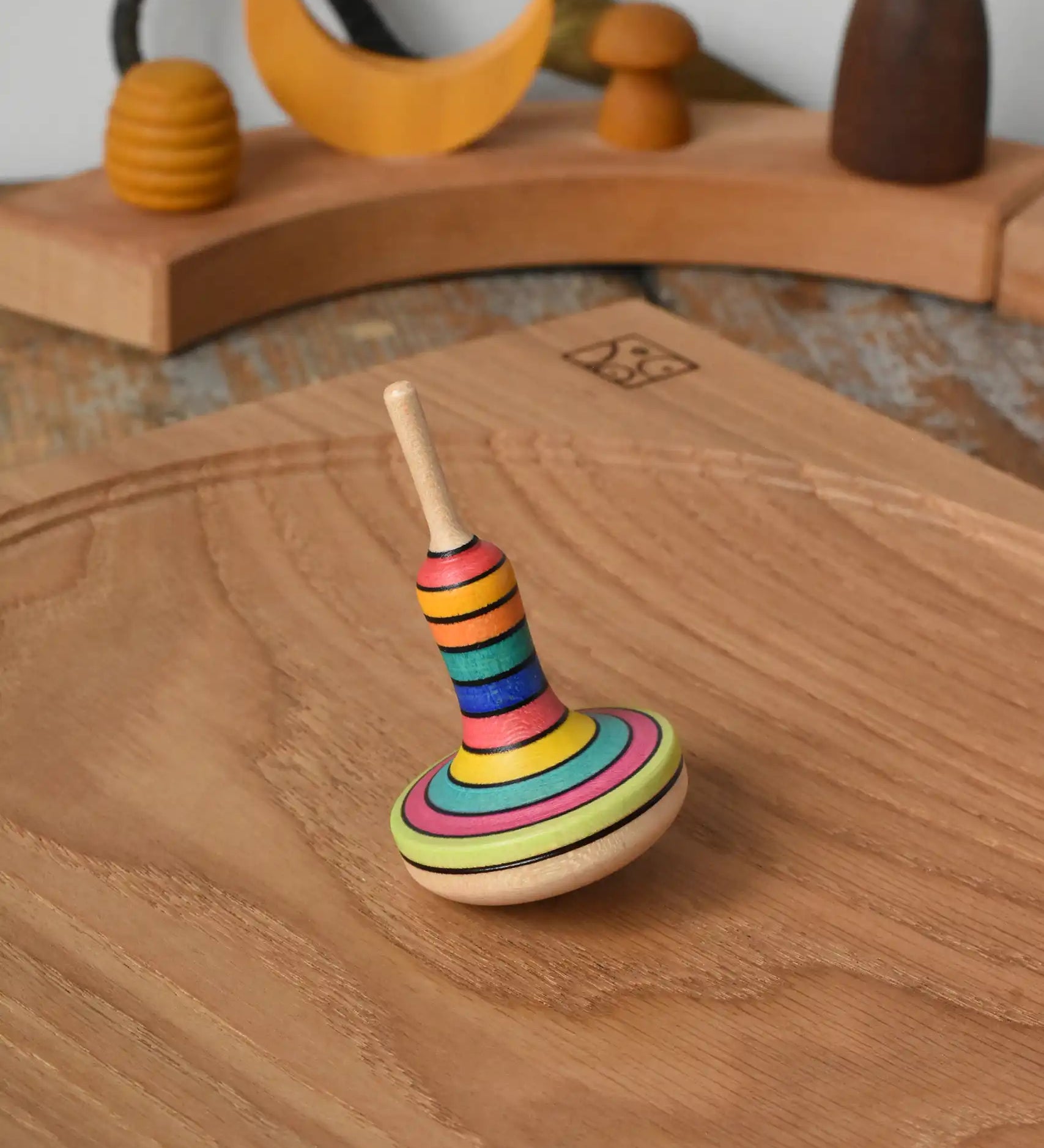 Mader Monalotte Spinning Top on a oak spinning plate in the Babipur playroom.
