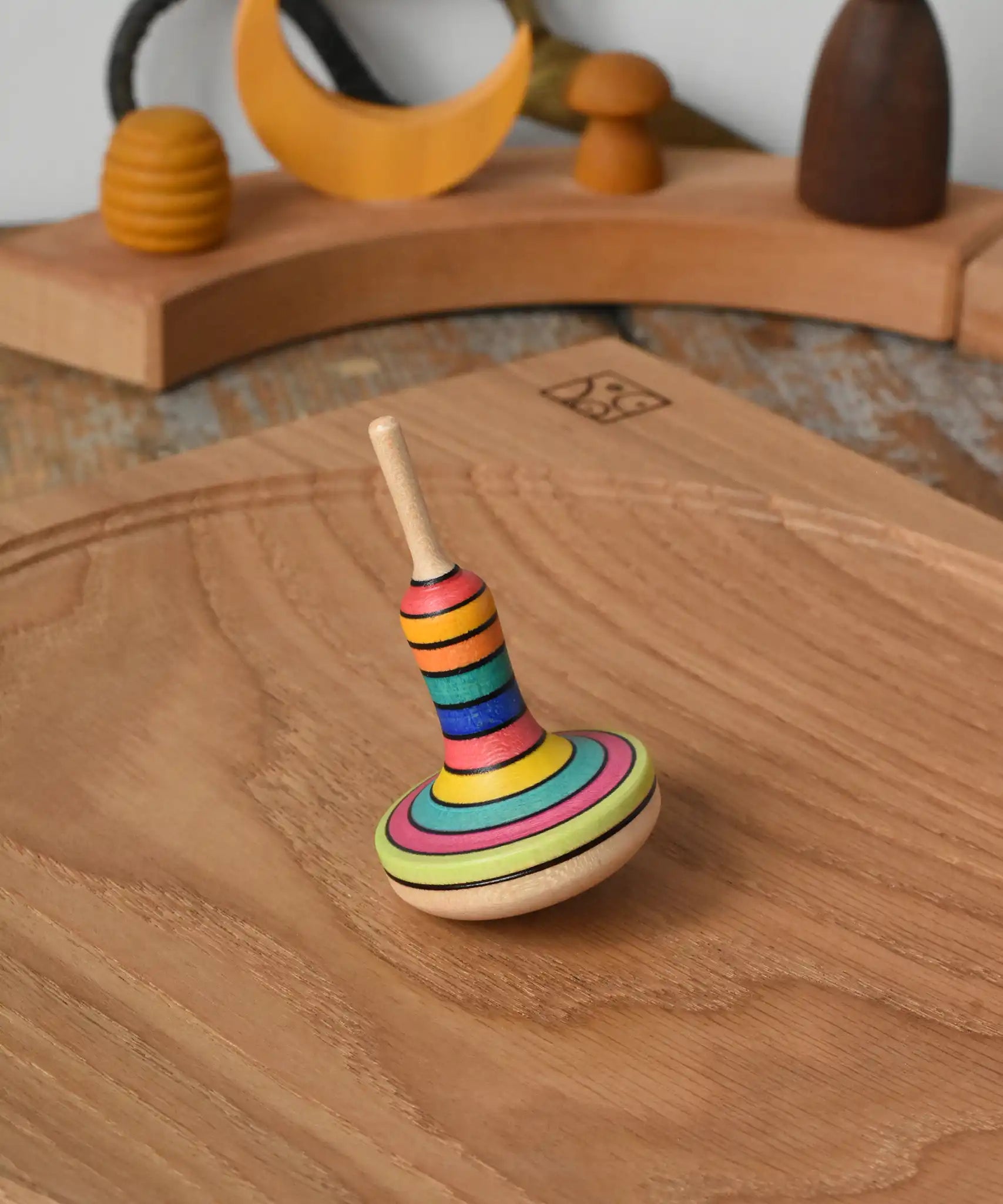 Mader Monalotte Spinning Top on a oak spinning plate in the Babipur playroom.