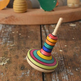 Mader Monalotte Spinning Top on a wooden surface in the Babipur playroom.