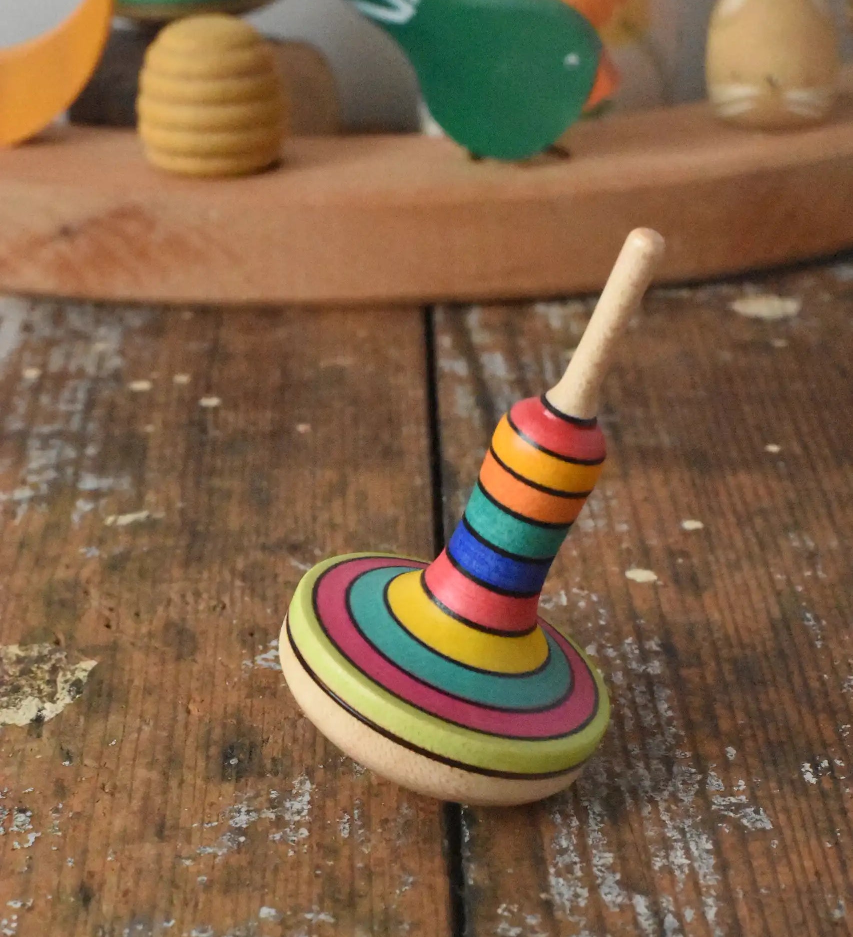 Mader Monalotte Spinning Top on a wooden surface in the Babipur playroom.