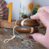 Side view of the Mader natural freewheel yoyo in an adult hand.