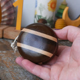 Mader natural freewheel yoyo in an adult's hand.