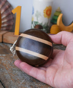 Mader natural freewheel yoyo in an adult's hand.