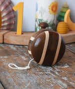 Mader natural freewheel yoyo placed on a wooden surface in the Babipur playroom.