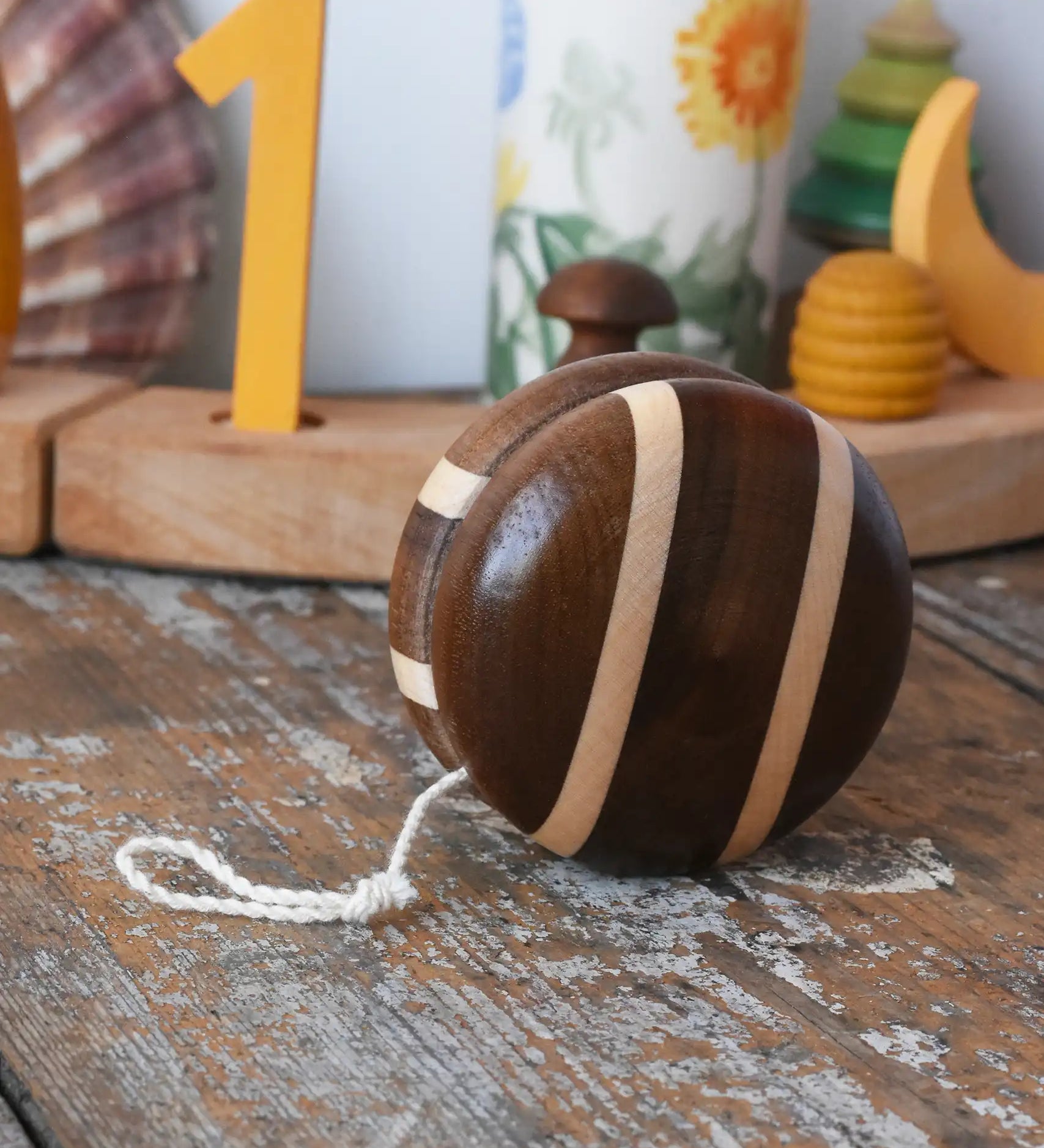Mader natural freewheel yoyo placed on a wooden surface in the Babipur playroom.