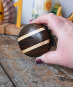 Mader natural yoyo in an adult hand in the Babipur playroom.