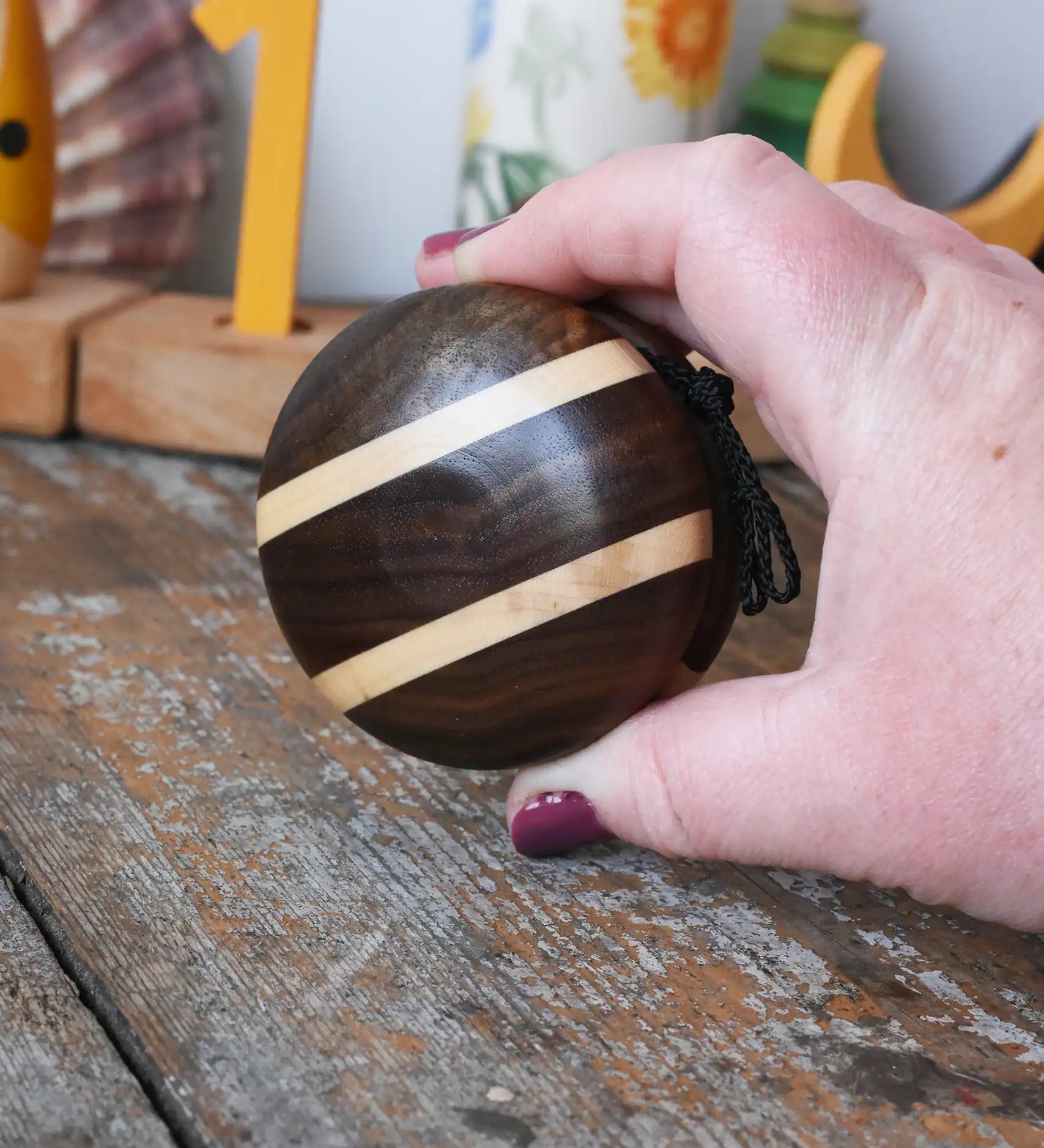 Mader natural yoyo in an adult hand in the Babipur playroom.