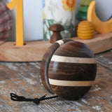 Mader natural yoyo placed on a wooden surface in the Babipur playroom.