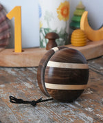 Mader natural yoyo placed on a wooden surface in the Babipur playroom.