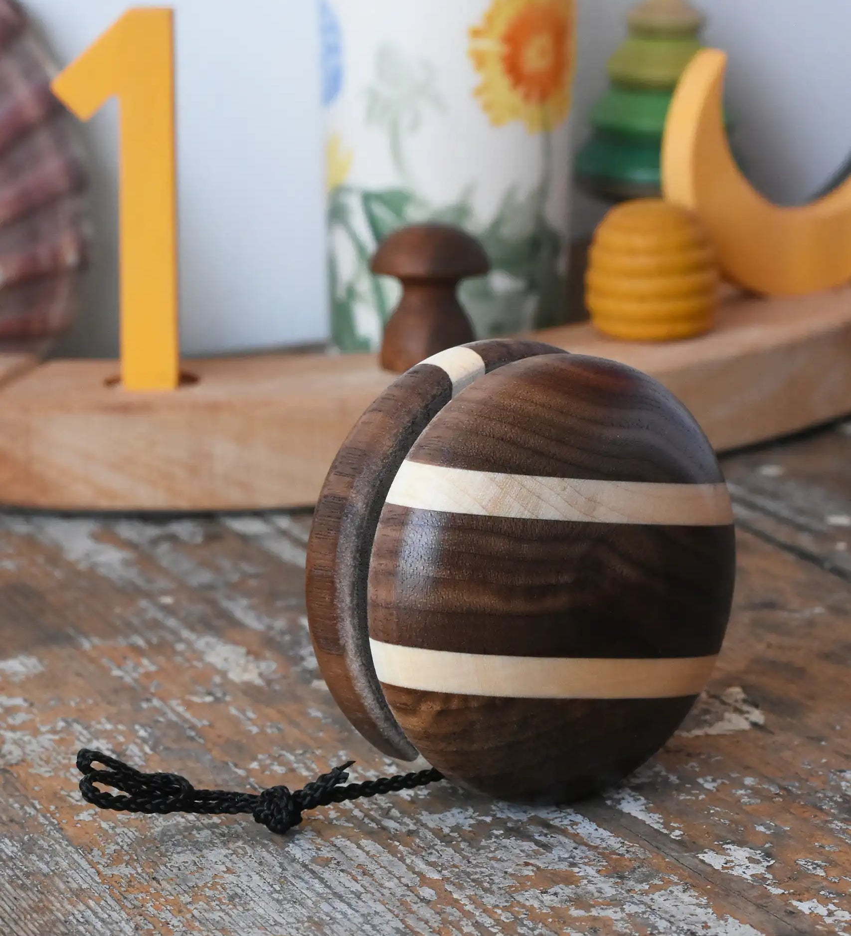Mader natural yoyo placed on a wooden surface in the Babipur playroom.