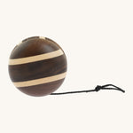A natural wooden Mader yo yo with black string and different woods, showcasing the unique grains and colours of the natural wood on a cream background.