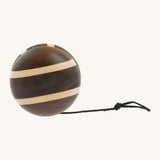 A natural wooden Mader yo yo with black string and different woods, showcasing the unique grains and colours of the natural wood on a cream background.