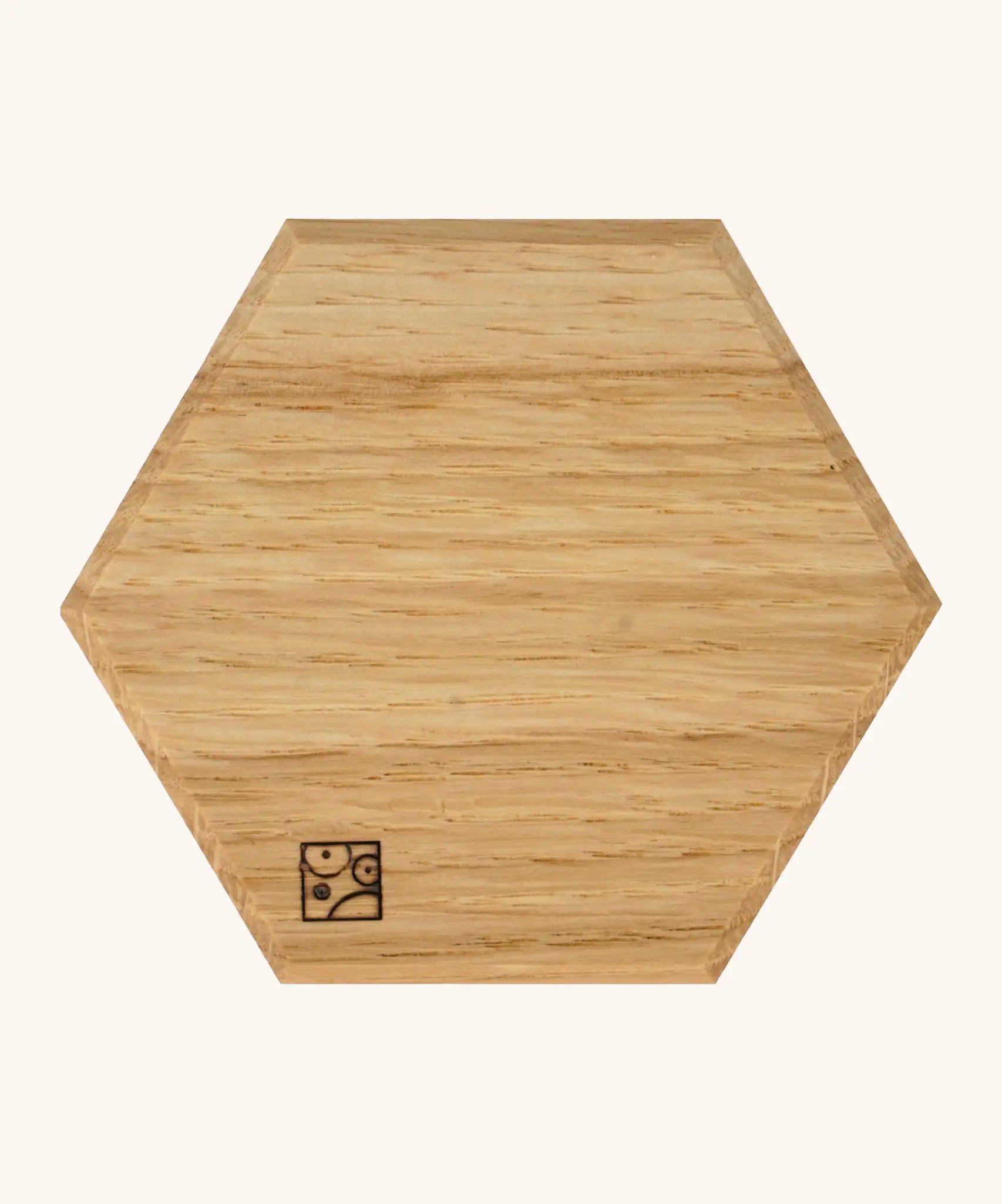underside of the Mader handcrafted small oak spinning top plate in a shape of a hexagon showing the logo on the corner