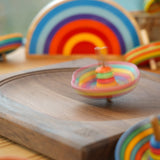 Mader striped sombrero spinning top twirling around on a mader spinning plate in front of a lanka kade x babipur sunset
