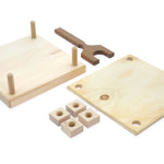 Pieces of the Mader plastic-free carved wooden flower press kit laid out on a white background