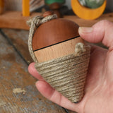 Mader natural profi throw spinning top in an adult hand.