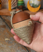 Mader natural profi throw spinning top in an adult hand.
