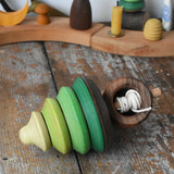 Mader pull-string tree spinning top placed on a wooden surface in the Babipur playroom.