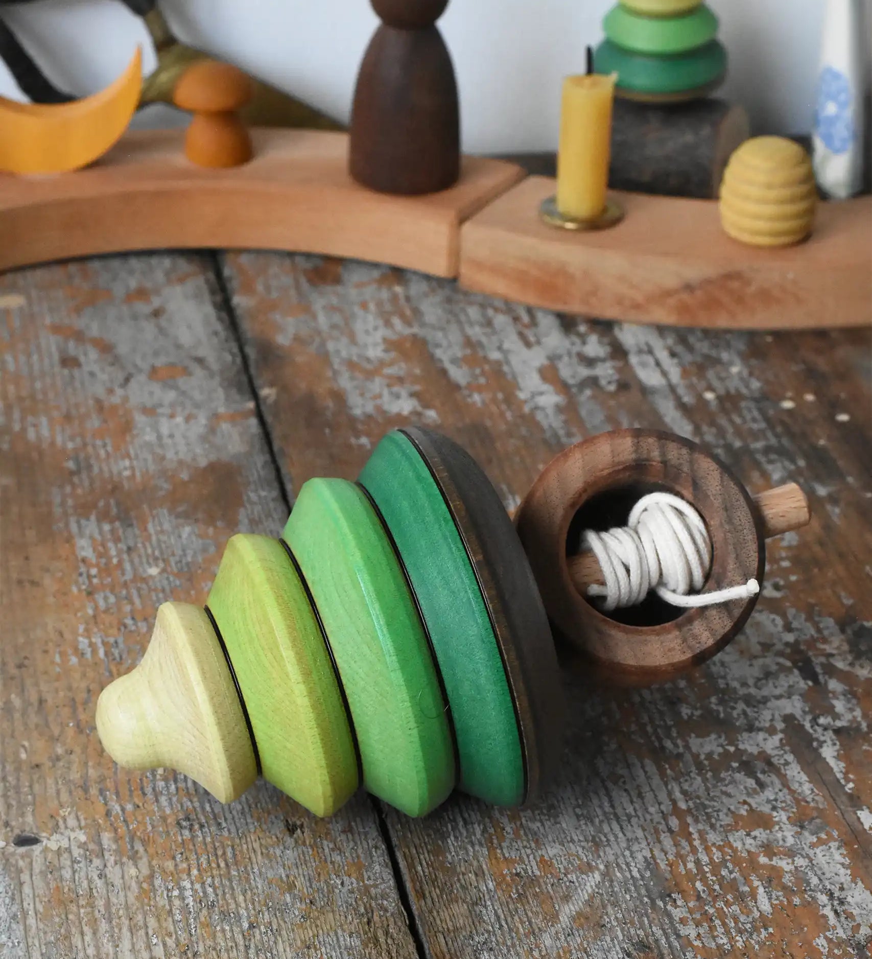 Mader pull-string tree spinning top placed on a wooden surface in the Babipur playroom.