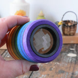 Mader Rainbow Kaleidoscope in an adult hand in the Babipur playroom. 