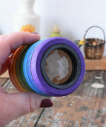 Mader Rainbow Kaleidoscope in an adult hand in the Babipur playroom. 