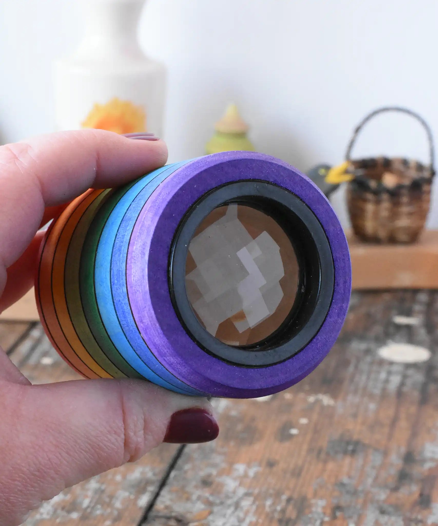 Mader Rainbow Kaleidoscope in an adult hand in the Babipur playroom. 