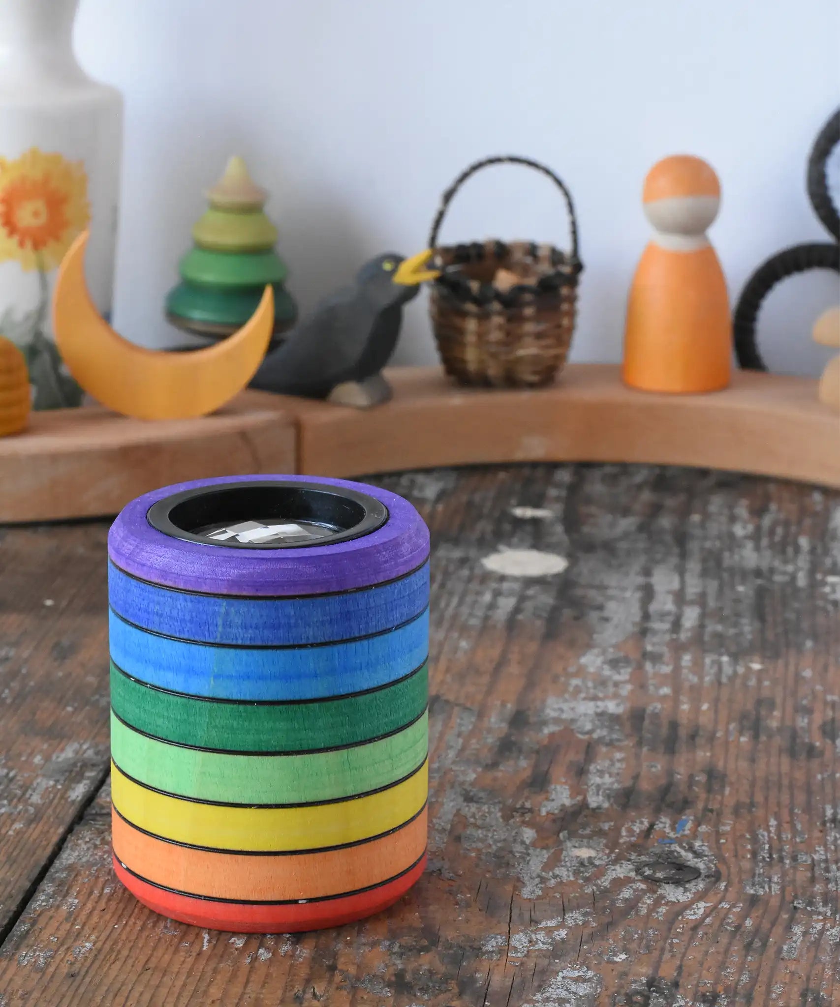 Mader Rainbow Kaleidoscope placed on a desk in the Babipur playroom. Decorated Grimm's celebration ring in the background.