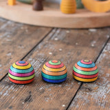 Three Mader striped wooden magnets placed on a desk in the Babipur playroom.