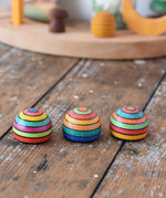 Three Mader striped wooden magnets placed on a desk in the Babipur playroom.