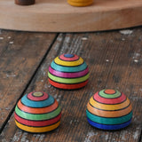 Three Mader striped wooden magnets placed on a desk in the Babipur playroom.