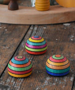Three Mader striped wooden magnets placed on a desk in the Babipur playroom.