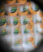 Mader Rainbow Kaleidoscope view through the lens of a tree spinning top and Grimm's moon decorative figure.