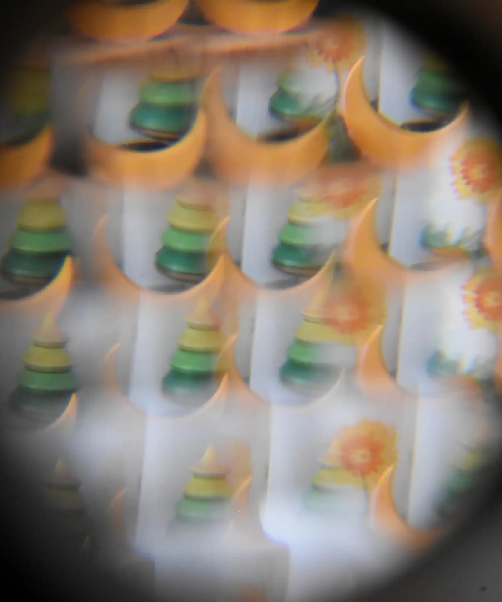 Mader Rainbow Kaleidoscope view through the lens of a tree spinning top and Grimm's moon decorative figure.