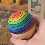 Mader Kreiselmanufaktur rainbow wobble in an adult's hand.