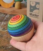 Mader Kreiselmanufaktur rainbow wobble in an adult's hand.
