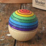 Mader Kreiselmanufaktur rainbow wobble placed on a wooden desk in the Babipur playroom.