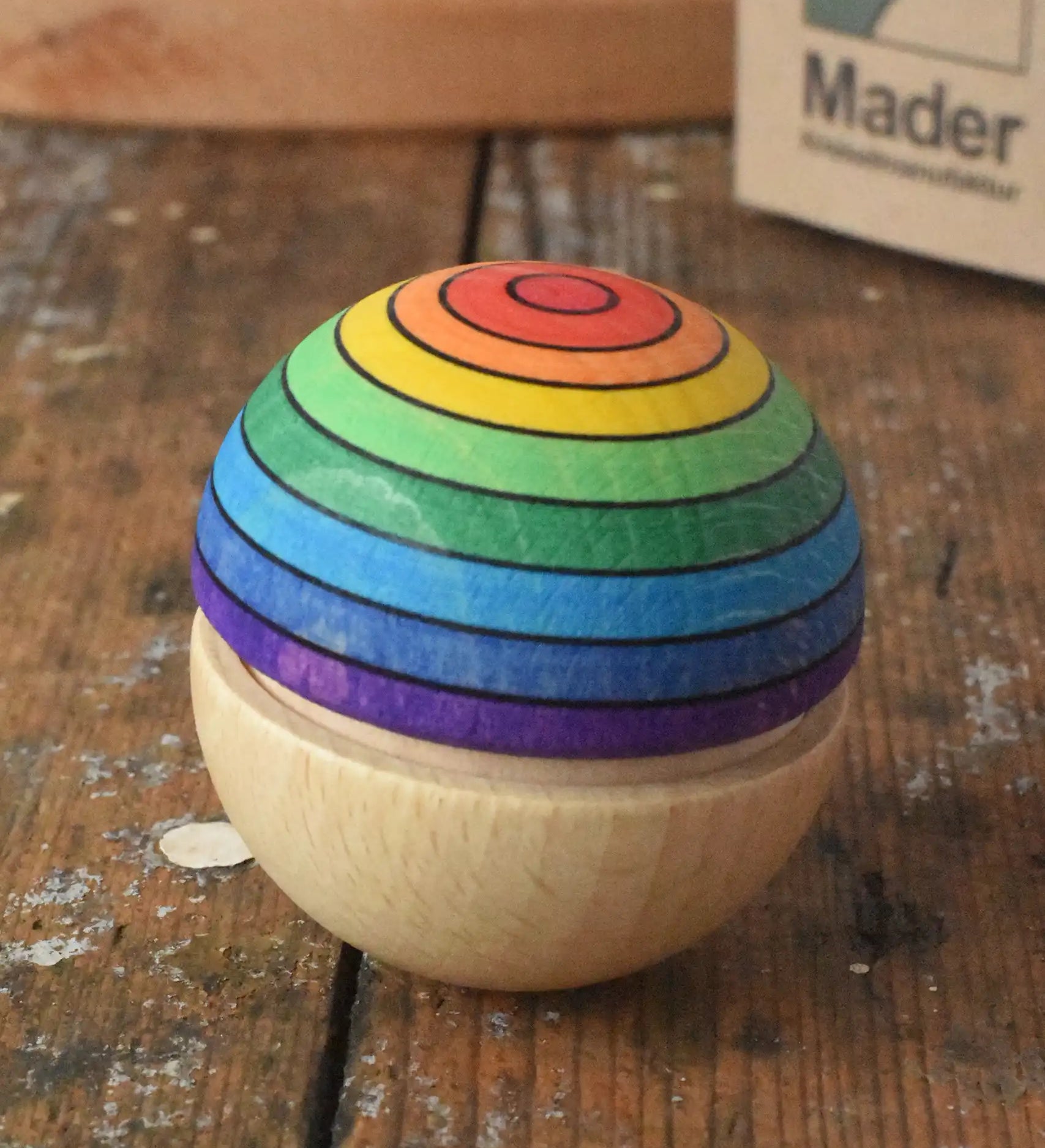 Mader Kreiselmanufaktur rainbow wobble placed on a wooden desk in the Babipur playroom.