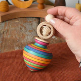 Mader Kreiselmanufaktur ring pull string spinning top placed on a cloth in the Babipur playroom.